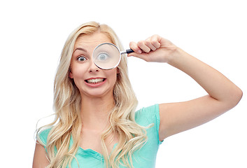 Image showing happy young woman with magnifying glass