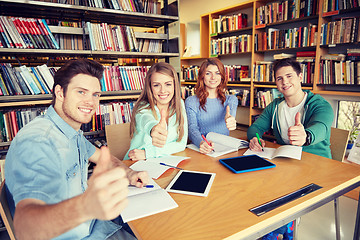 Image showing happy students showing thumbs up in school library