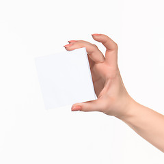 Image showing Female hand holding blank paper for records on white.