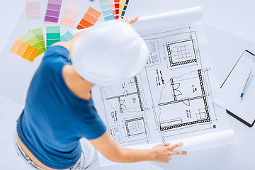 Image showing woman with color samples and blueprint