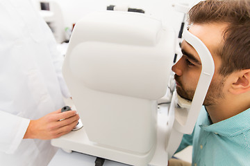 Image showing optician with autorefractor and patient at clinic