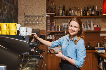 Image showing barista woman making coffee by machine at cafe