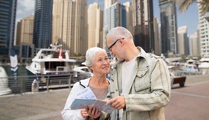 Image showing happy senior couple with city map over harbor