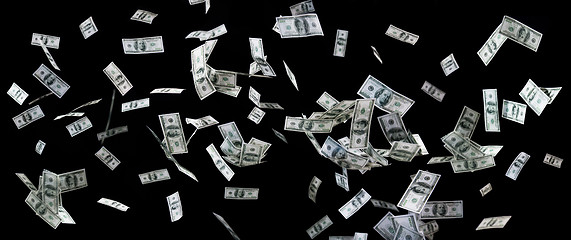 Image showing close up of us dollar money flying over black