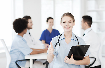 Image showing happy doctor over group of medics at hospital