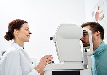 Image showing optician with tonometer and patient at eye clinic