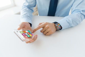 Image showing close up of hands with smart phone and watch