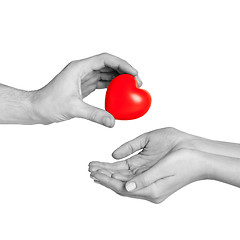 Image showing man hand giving red heart to woman