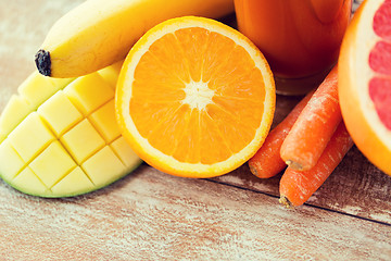 Image showing close up of fresh fruits and juice glass on table