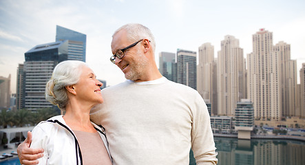 Image showing senior couple hugging over dubai city waterfront