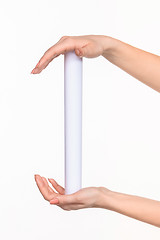 Image showing The cylinder female hands on white background