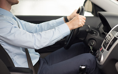 Image showing close up of young man driving car