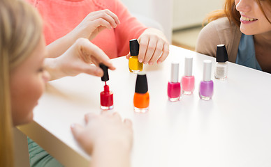 Image showing close up of smiling young women with nail polish