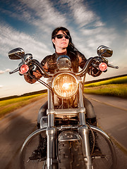 Image showing Biker girl sitting on motorcycle