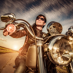 Image showing Biker girl sitting on motorcycle