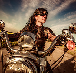 Image showing Biker girl sitting on motorcycle