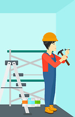 Image showing Constructor hammering nail.