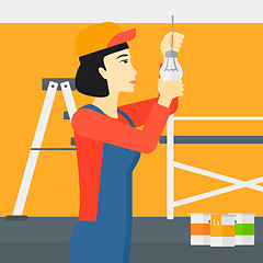 Image showing Electrician twisting light bulb.