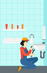 Image showing Woman repairing sink.