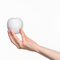 Image showing The female hand holding white blank styrofoam oval 