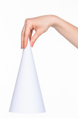 Image showing The white cone in the  female hands on white background