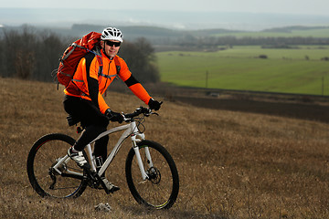 Image showing Man cyclist with backpack riding the bicycle