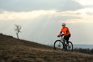 Image showing Man cyclist with backpack riding the bicycle