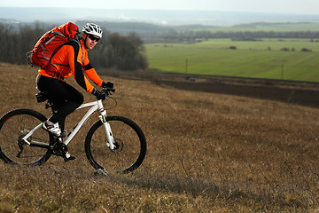 Image showing Man cyclist with backpack riding the bicycle