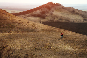 Image showing Man cyclist with backpack riding the bicycle