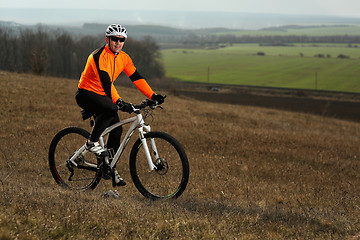 Image showing Man cyclist with backpack riding the bicycle