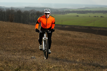 Image showing Man cyclist with backpack riding the bicycle