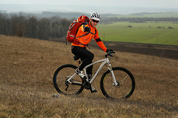 Image showing Man cyclist with backpack riding the bicycle