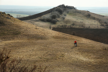 Image showing Man cyclist with backpack riding the bicycle