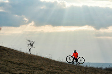 Image showing Man cyclist with backpack riding the bicycle