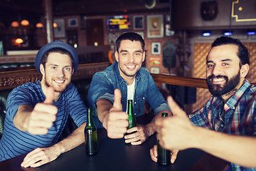 Image showing happy male friends drinking beer at bar or pub