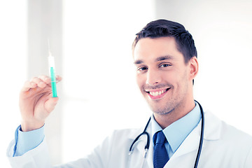 Image showing male doctor holding syringe with injection