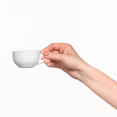 Image showing Woman hand with cup on white background