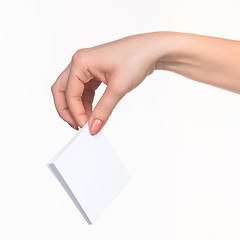 Image showing Female hand holding blank paper for records on white.