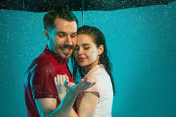 Image showing The loving couple in the rain