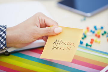 Image showing Attention please text on adhesive note