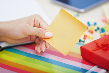 Image showing Hand of woman with blank adhesive note