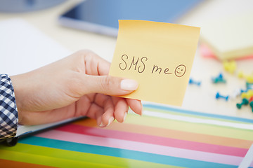 Image showing SMS me text on adhesive note