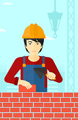 Image showing Bricklayer with spatula and brick.