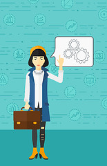 Image showing Business woman pointing at cogwheels.