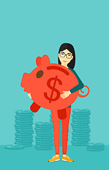 Image showing Woman carrying piggy bank.