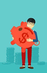 Image showing Man carrying piggy bank.