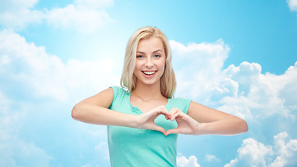 Image showing happy woman or teen girl showing heart shape sigh