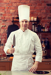 Image showing happy male chef cook in kitchen with knife