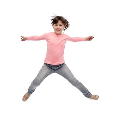 Image showing happy little girl jumping in air