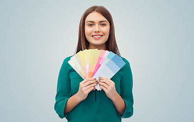 Image showing smiling young woman with color swatches